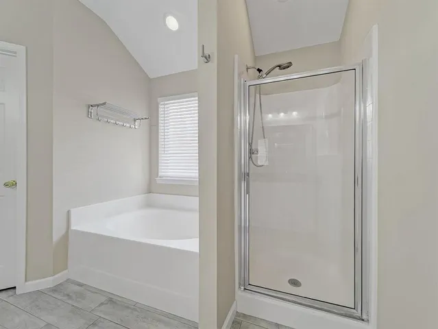 a white bath tub sitting next to a shower