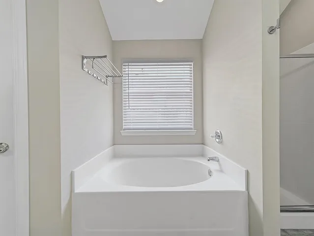 a white bath tub sitting next to a window