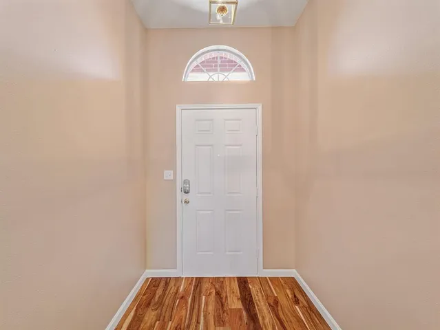 a view of front door with wooden floor