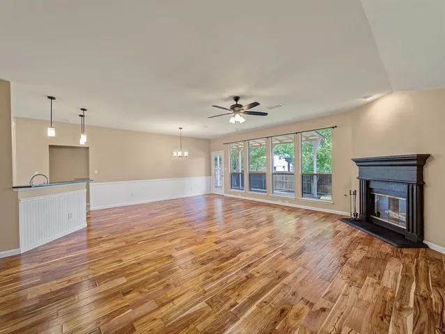 a view of an empty room with a fireplace and a window