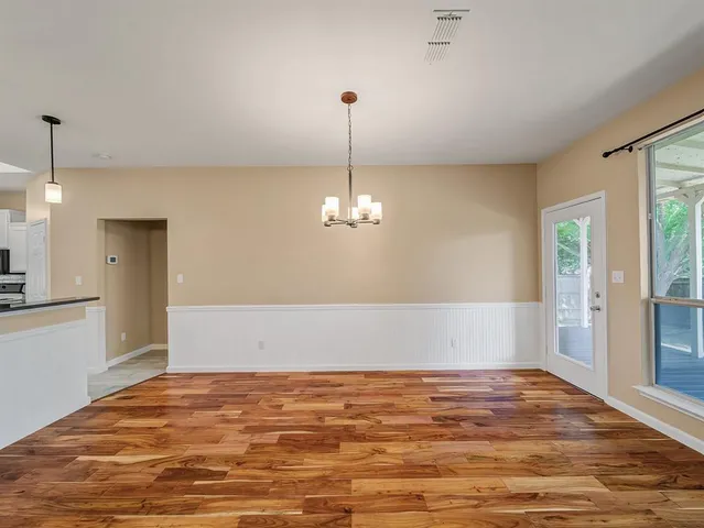 a view of a room with window wooden floor and a ceiling fan
