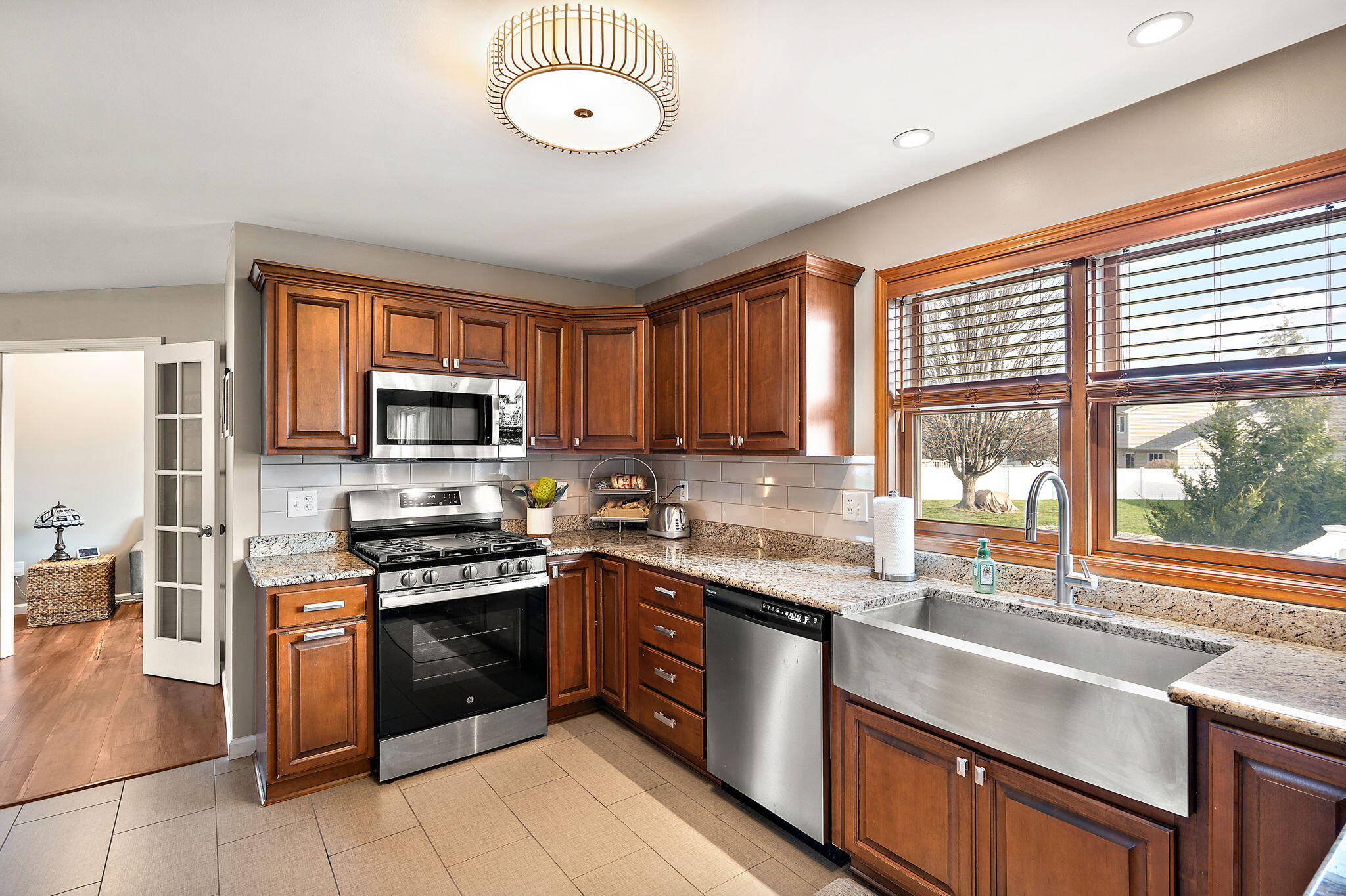 412 Chessington Drive Crown Point, IN 46307 - Photo 5 of 30 a kitchen with stainless steel appliances granite countertop a stove sink and microwave