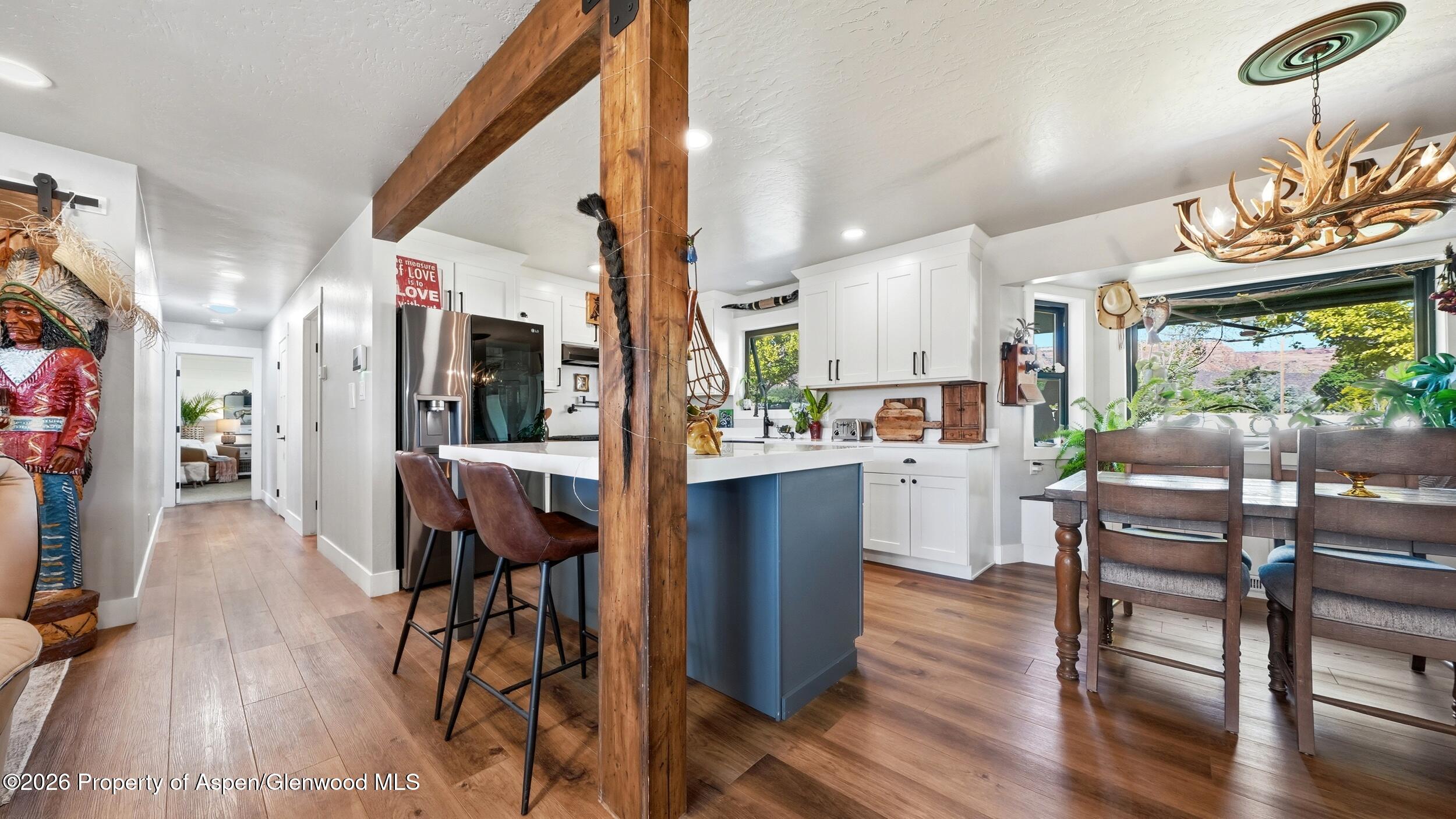 445 South Camp Road Grand Junction, CO 81507 - Photo 10 of 37 a living room with stainless steel appliances kitchen island granite countertop furniture and a wooden floor