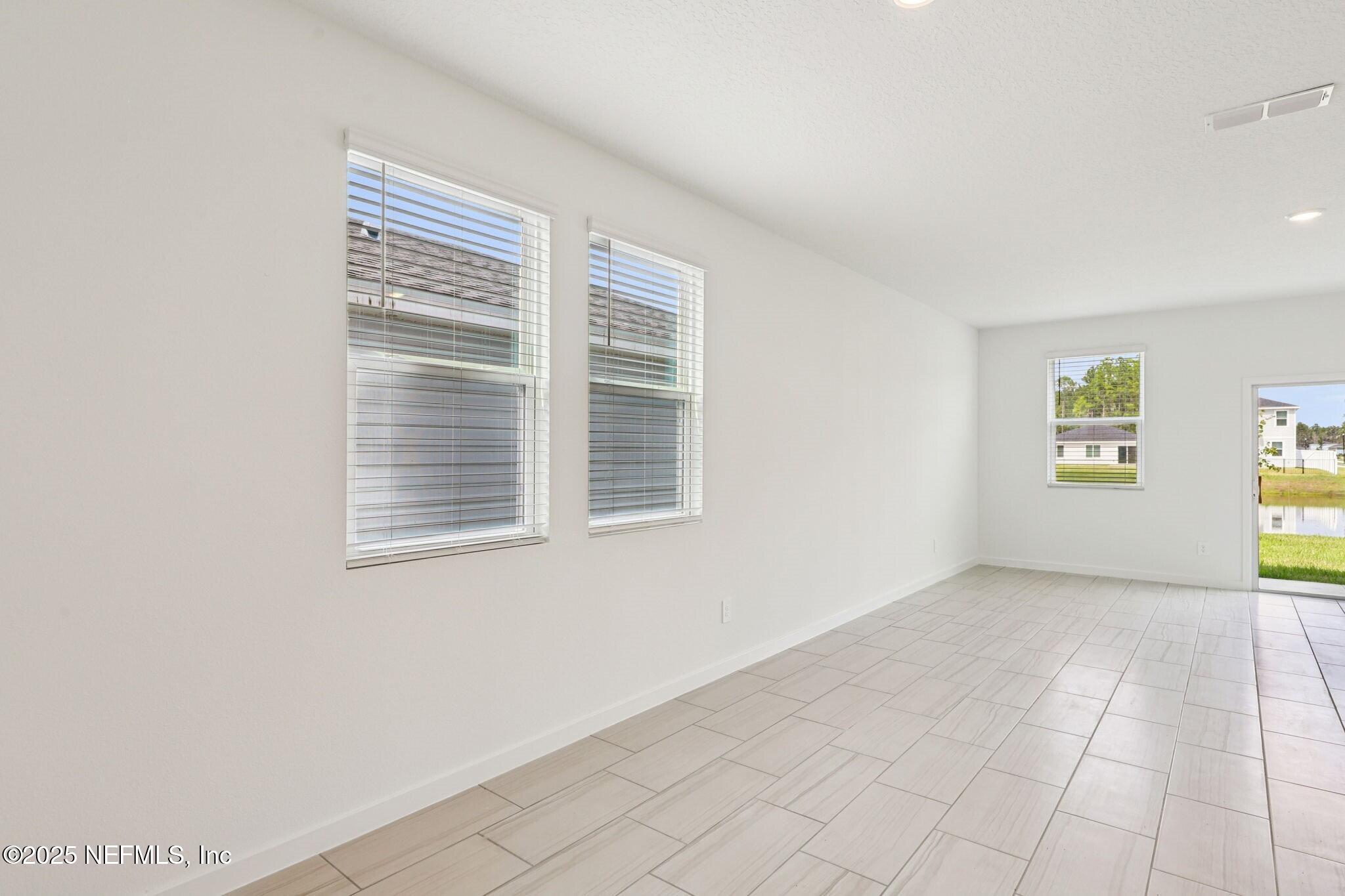 9638 Cypress Mdws Road Jacksonville, FL 32219 - Photo 11 of 35 a view of an empty room with a window