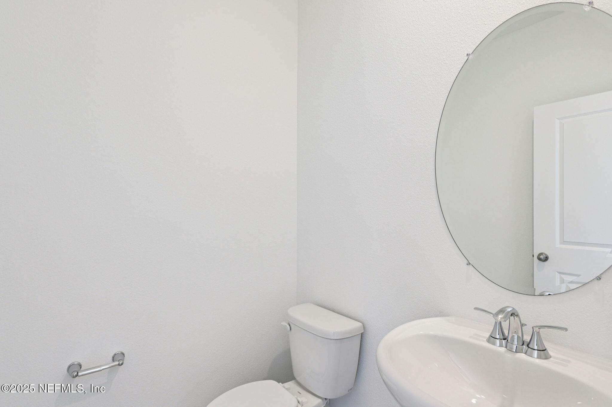 9638 Cypress Mdws Road Jacksonville, FL 32219 - Photo 16 of 35 a bathroom with a toilet sink and mirror