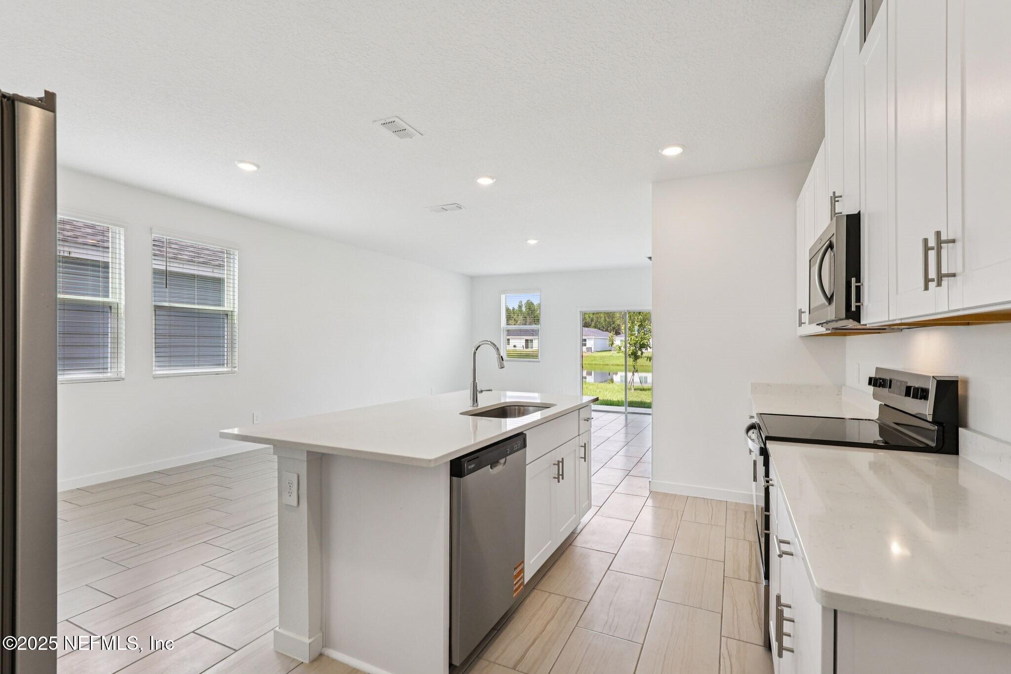 9638 Cypress Mdws Road Jacksonville, FL 32219 - Photo 2 of 35 a kitchen with stainless steel appliances a sink stove and cabinets