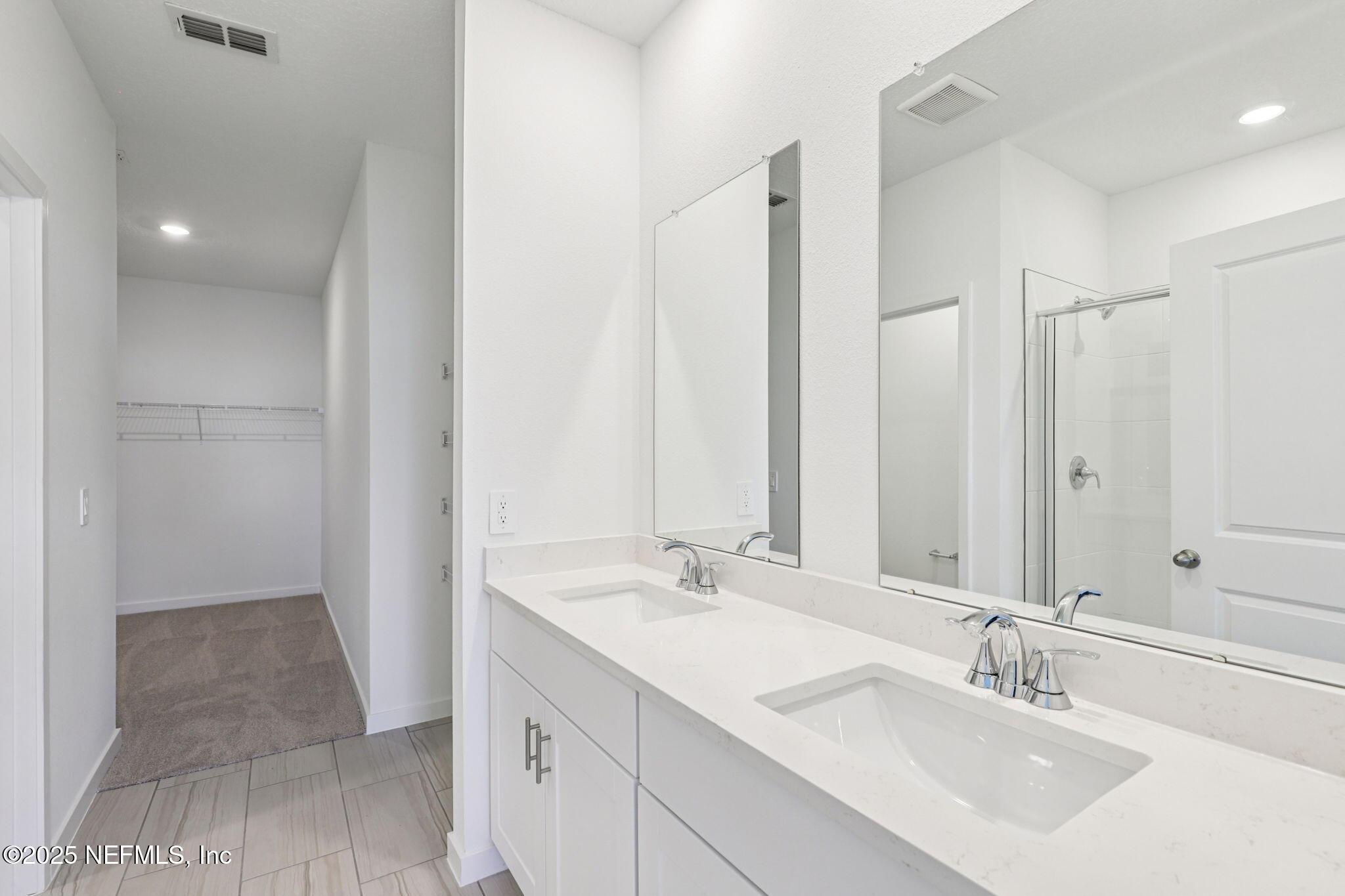 9638 Cypress Mdws Road Jacksonville, FL 32219 - Photo 22 of 35 a bathroom with double sink and a mirror