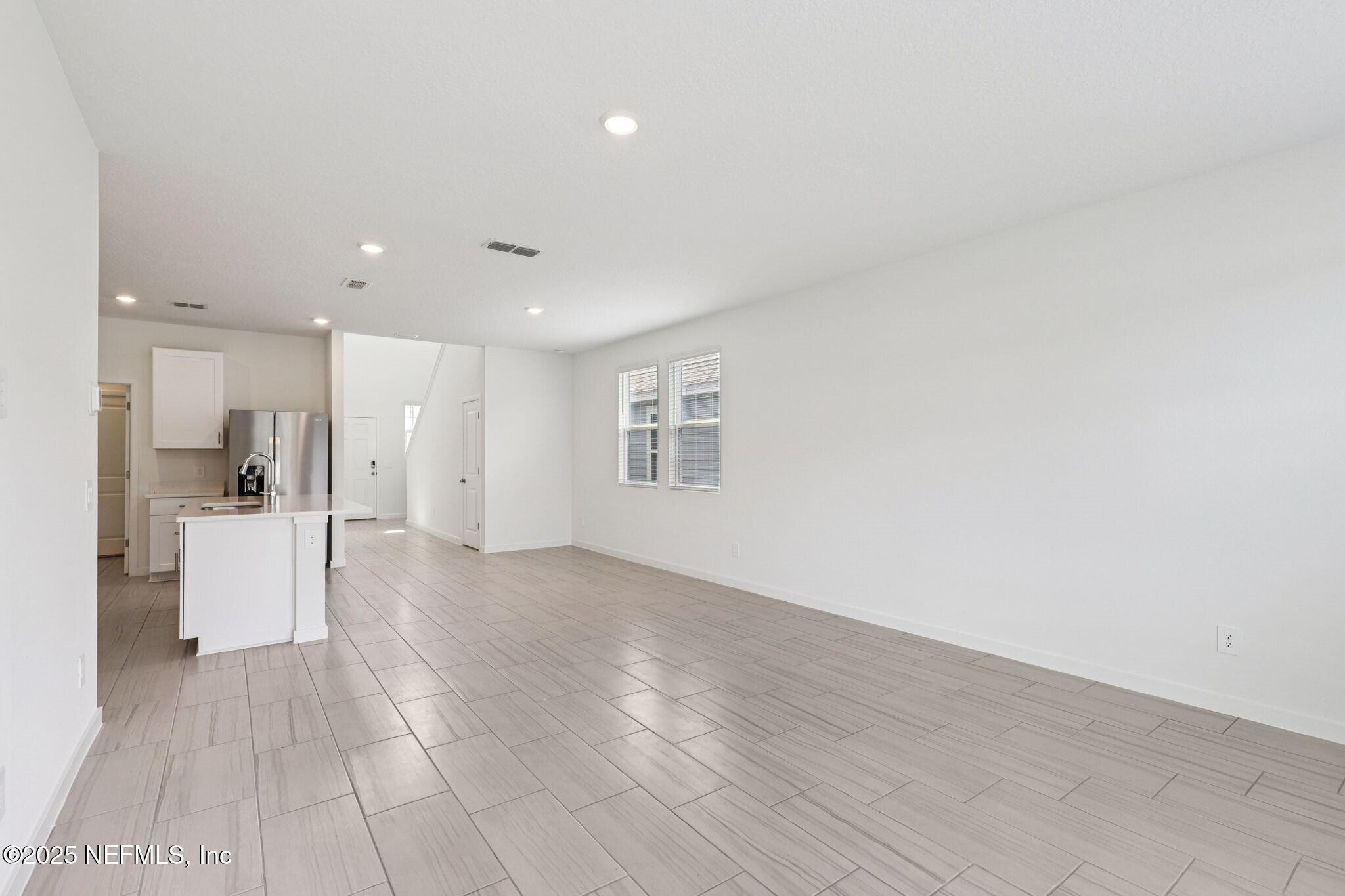 9638 Cypress Mdws Road Jacksonville, FL 32219 - Photo 7 of 35 a view of a living room with kitchen island stainless steel appliances wooden floor and view living room