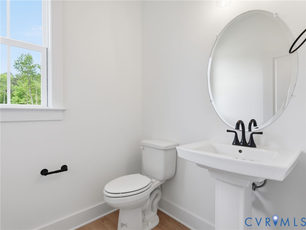 18112 Copper Fox Loop Moseley, VA 23120 - Photo 16 of 29 a bathroom with a sink toilet and mirror