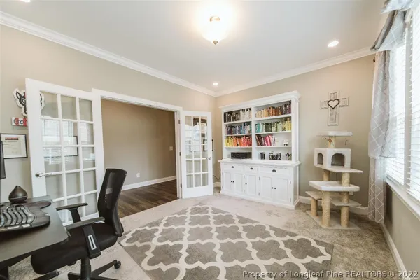 a living room with furniture a rug and a window