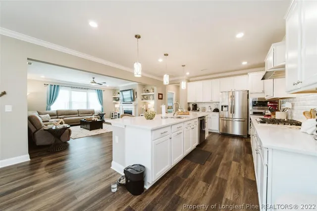 a kitchen with a table chairs refrigerator and cabinets