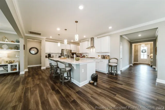a living room with furniture fireplace and a large window