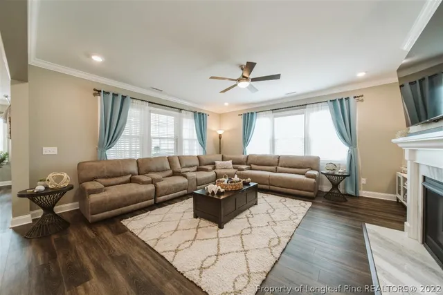 a living room with furniture fireplace and flat screen tv
