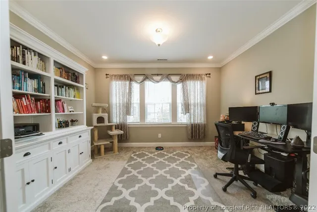 a spacious bedroom with a bed a large window with wooden floor