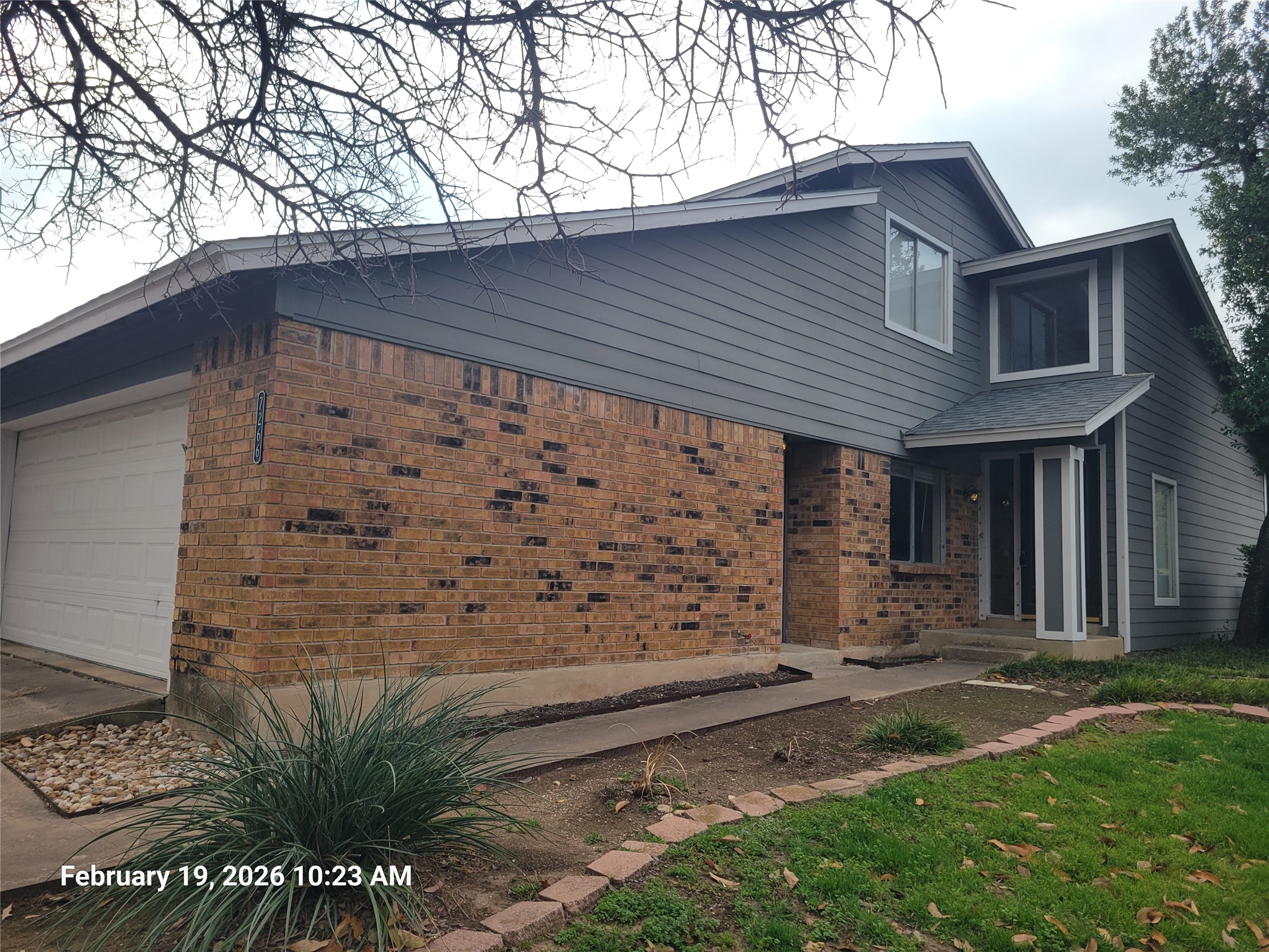 View of property exterior featuring brick siding