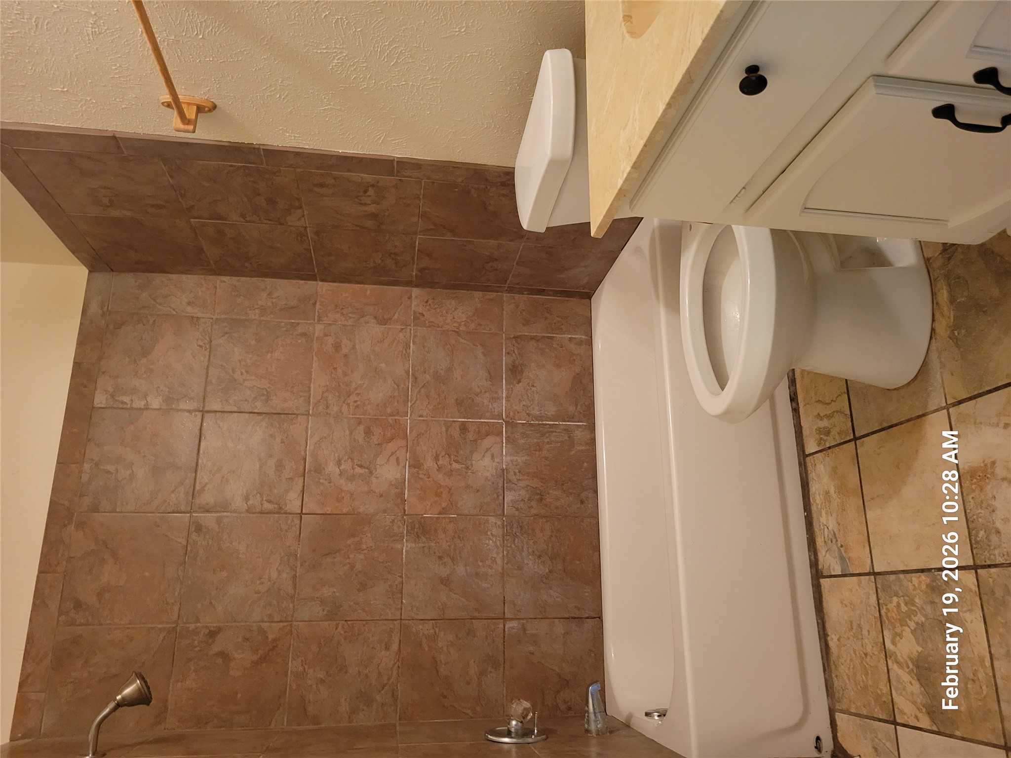 7266 Coronado Circle Austin, TX 78752 - Photo 6 of 11 Full bath featuring a textured wall, vanity, and tub / shower combination
