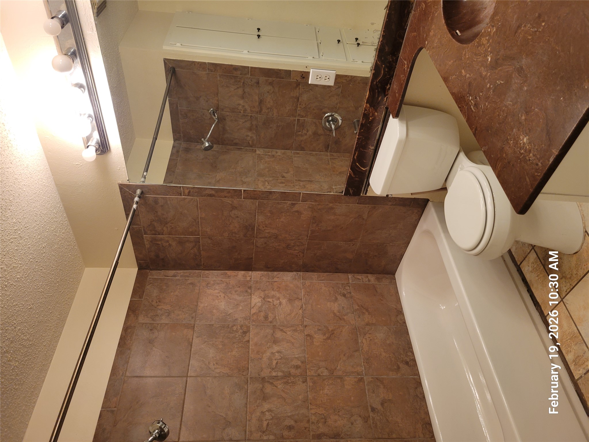 7266 Coronado Circle Austin, TX 78752 - Photo 8 of 11 Full bathroom with vanity, bathing tub / shower combination, a textured ceiling, and light tile patterned floors