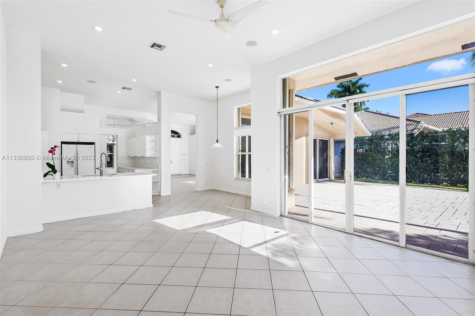 948 Windward Way Weston, FL 33327 - Photo 20 of 46 a view of a refrigerator in kitchen and white cabinets