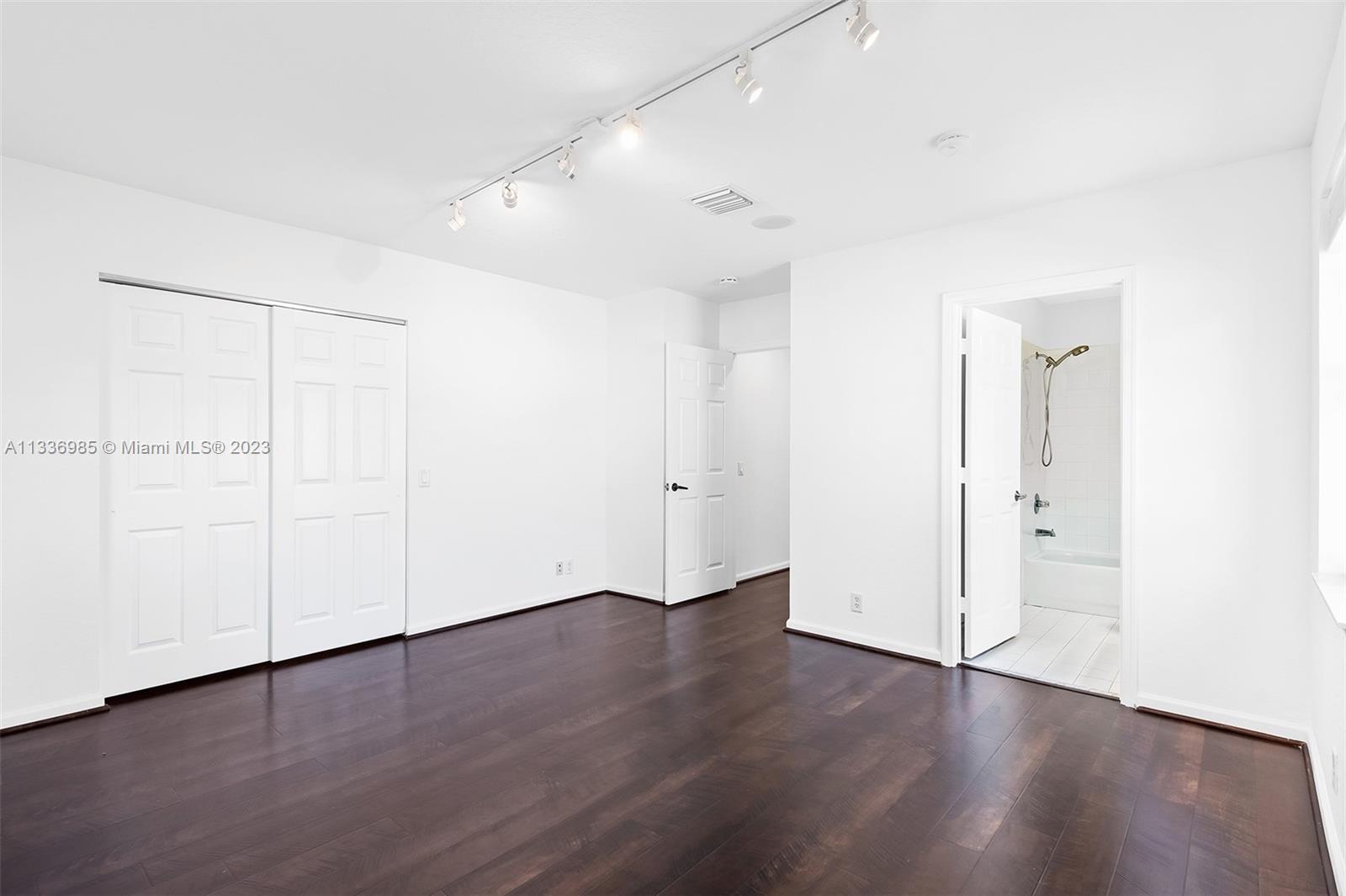 948 Windward Way Weston, FL 33327 - Photo 38 of 46 an empty room with wooden floor