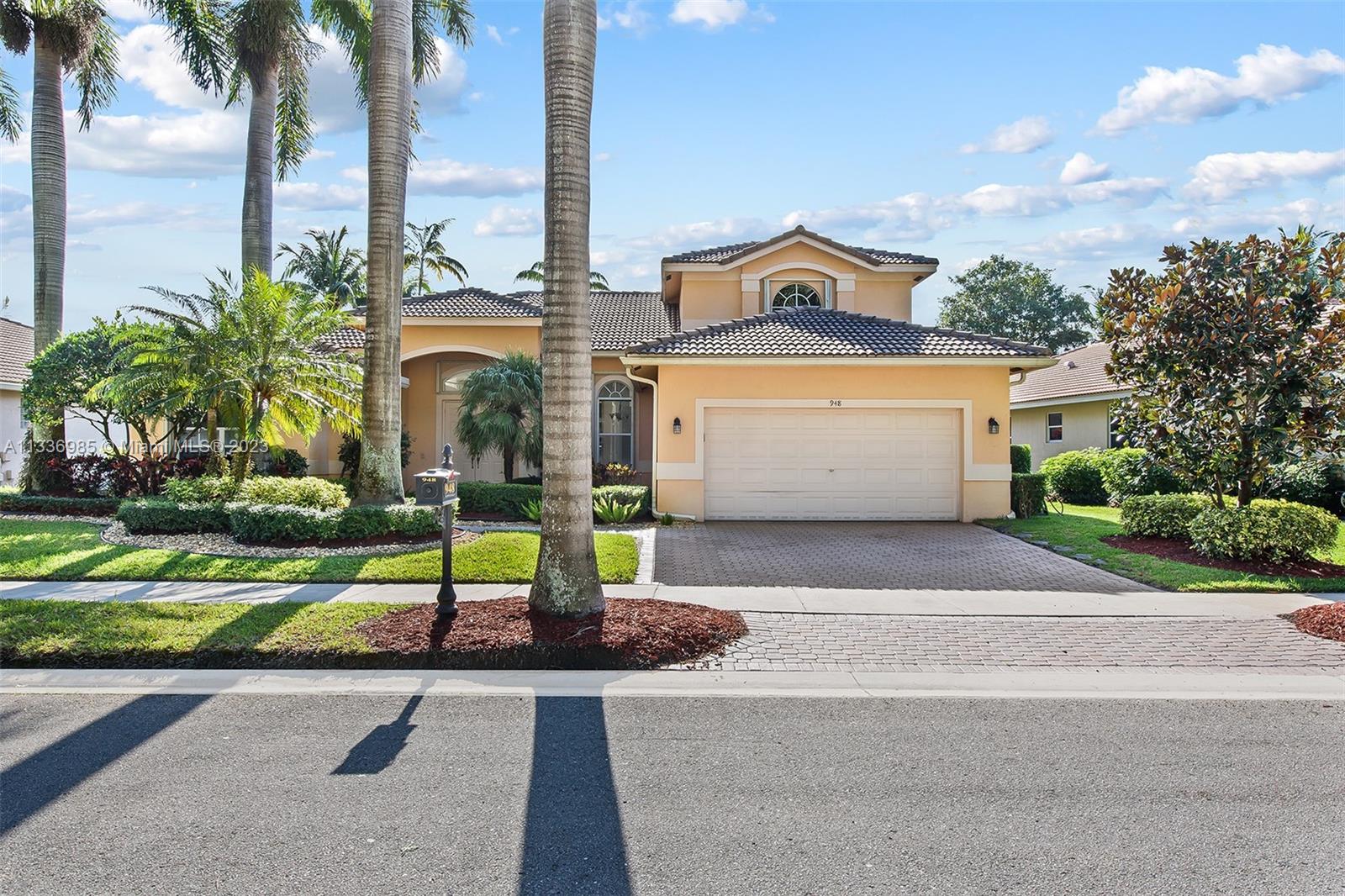 948 Windward Way Weston, FL 33327 - Photo 42 of 46 a front view of house with yard and green space