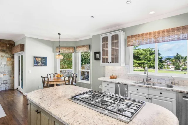 a dining room with furniture a chandelier and window