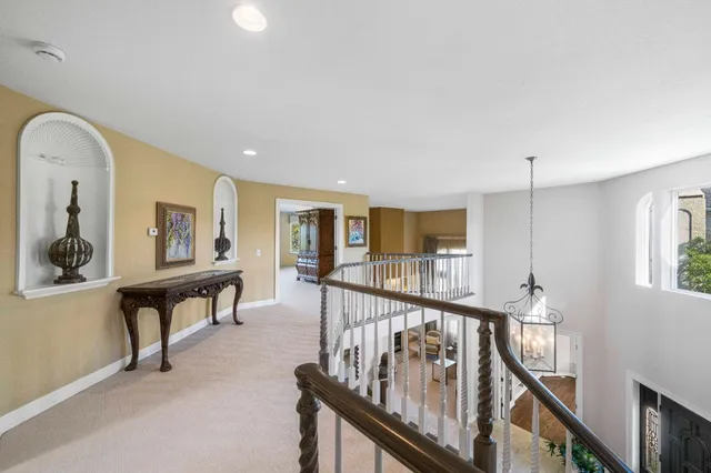 a bedroom with a bed and large windows