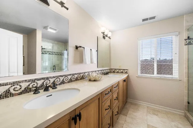 an aerial view of a residential houses with yard