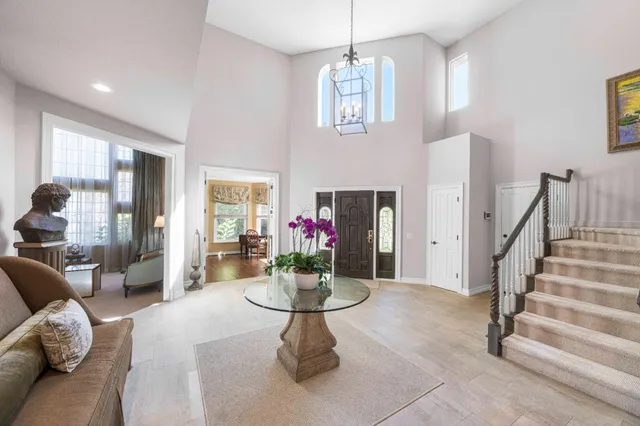 a bedroom with a bed and a chandelier