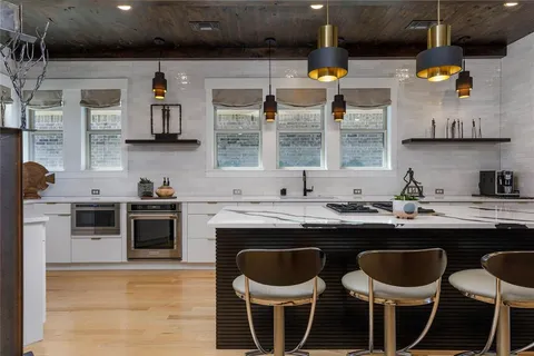 a kitchen with a sink cabinets and window