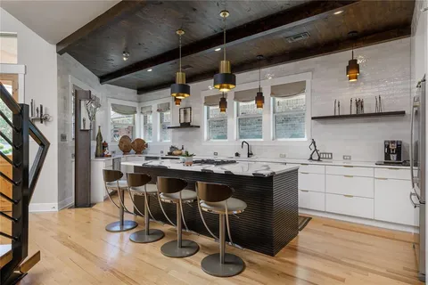 a kitchen with a sink cabinets and wooden floor