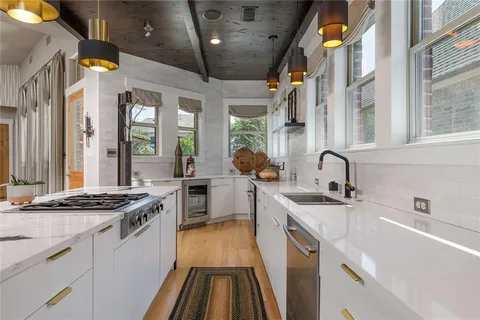 a kitchen with stainless steel appliances granite countertop a sink stove and cabinets