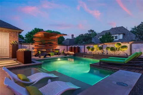 a view of a house with pool and a yard