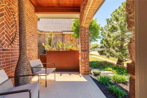 a view of a patio with table and chairs and potted plants