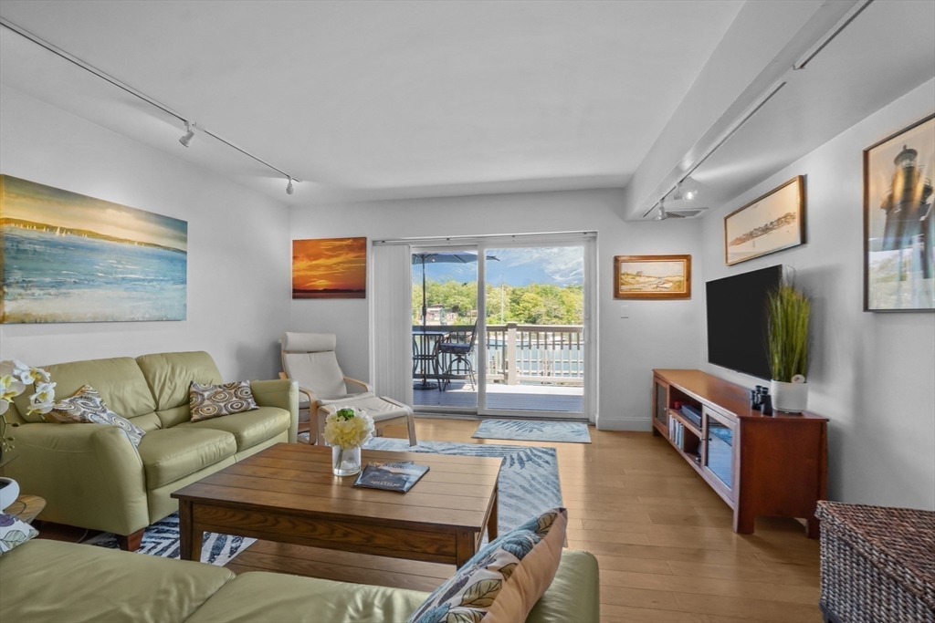 45 Main Street, Unit 112 Wareham, MA 02571 - Photo 5 of 30 a living room with furniture and a flat screen tv