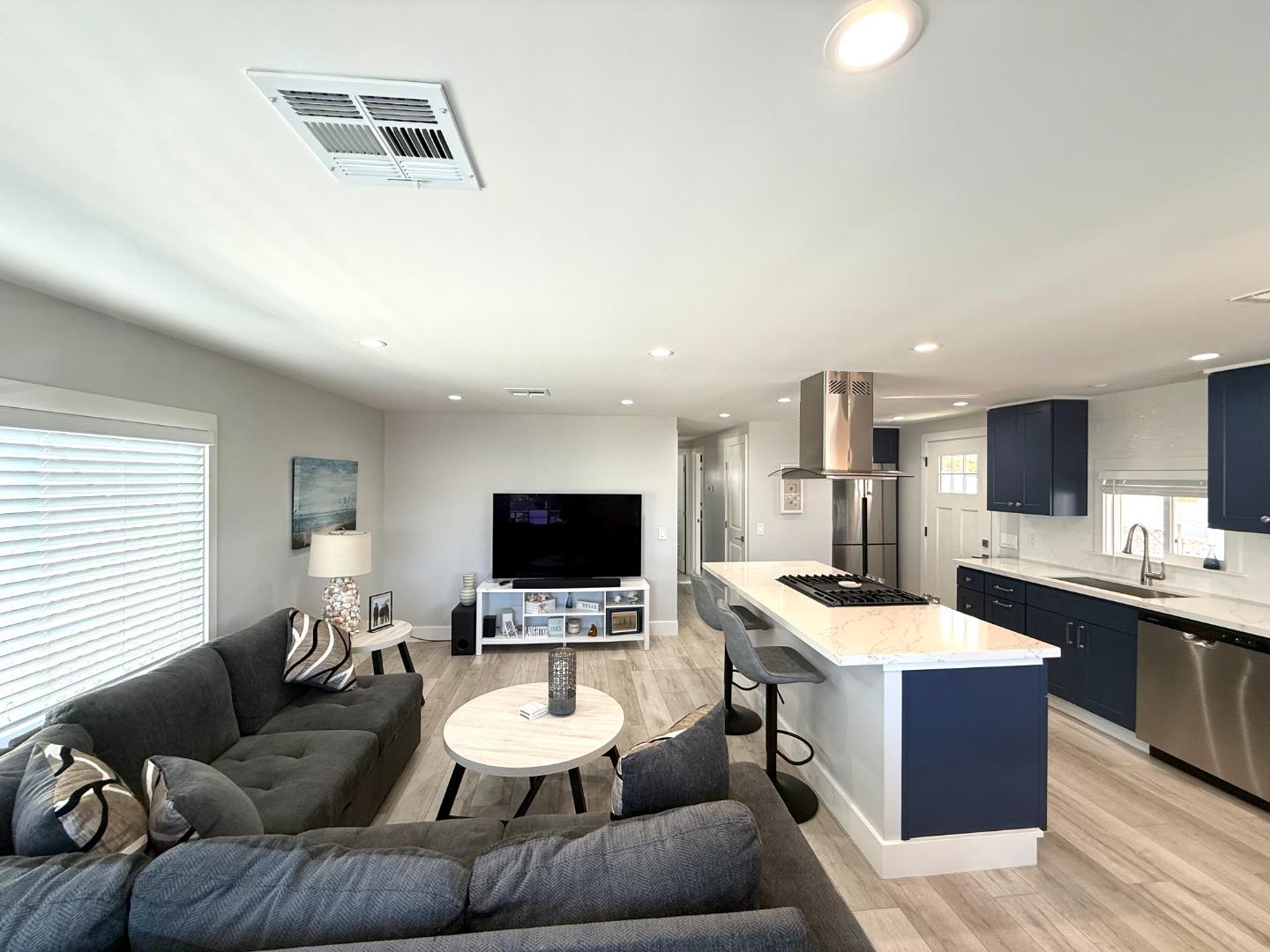 8 Lighthouse Road, Unit 8 Half Moon Bay, CA 94019 - Photo 5 of 21 a living room with furniture and a flat screen tv