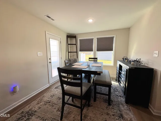 a view of a dining room with furniture and window