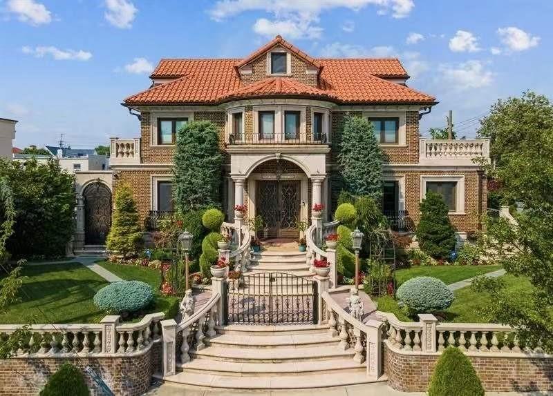 a front view of a house with a yard and potted plants