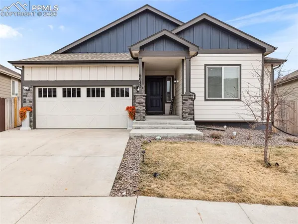 a front view of a house with garage