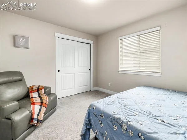 a bedroom with a bed and closet