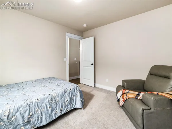 a bedroom with a bed and couch