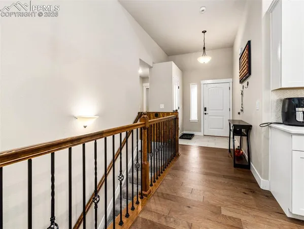 a view of a hallway with wooden floor