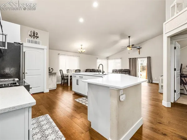 a kitchen with stainless steel appliances kitchen island a refrigerator and a stove top oven