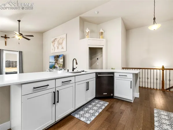 a kitchen with sink cabinets and wooden floor