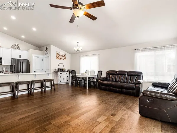 a living room with furniture and a wooden floor