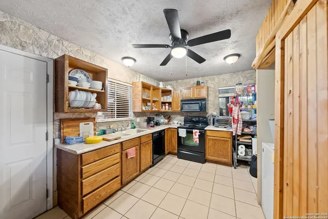 a kitchen with a stove a refrigerator and a sink