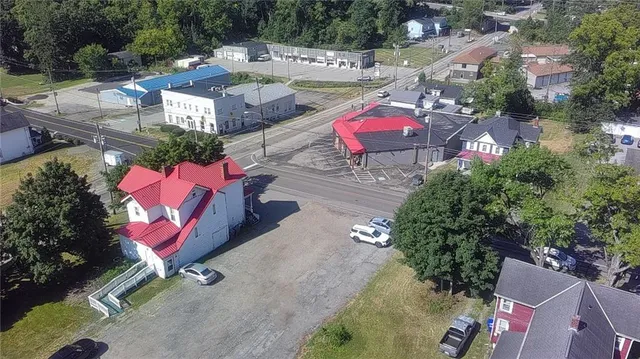 an aerial view of a swimming pool with outdoor seating