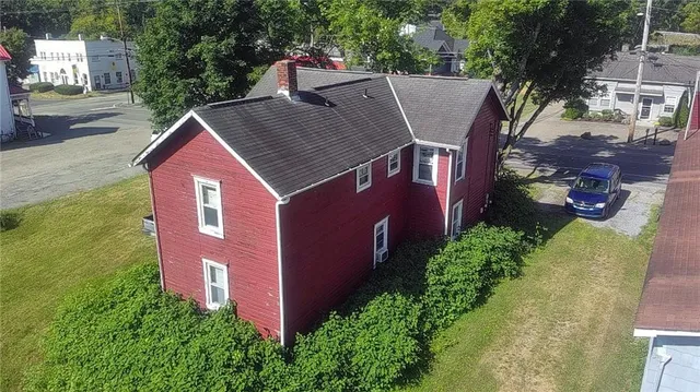an aerial view of a house with a yard and lake view