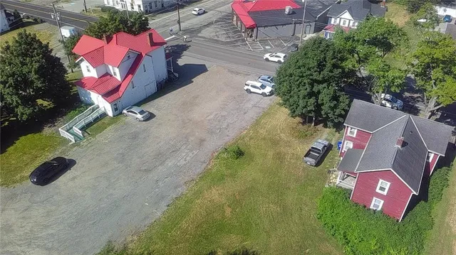an aerial view of residential house with yard