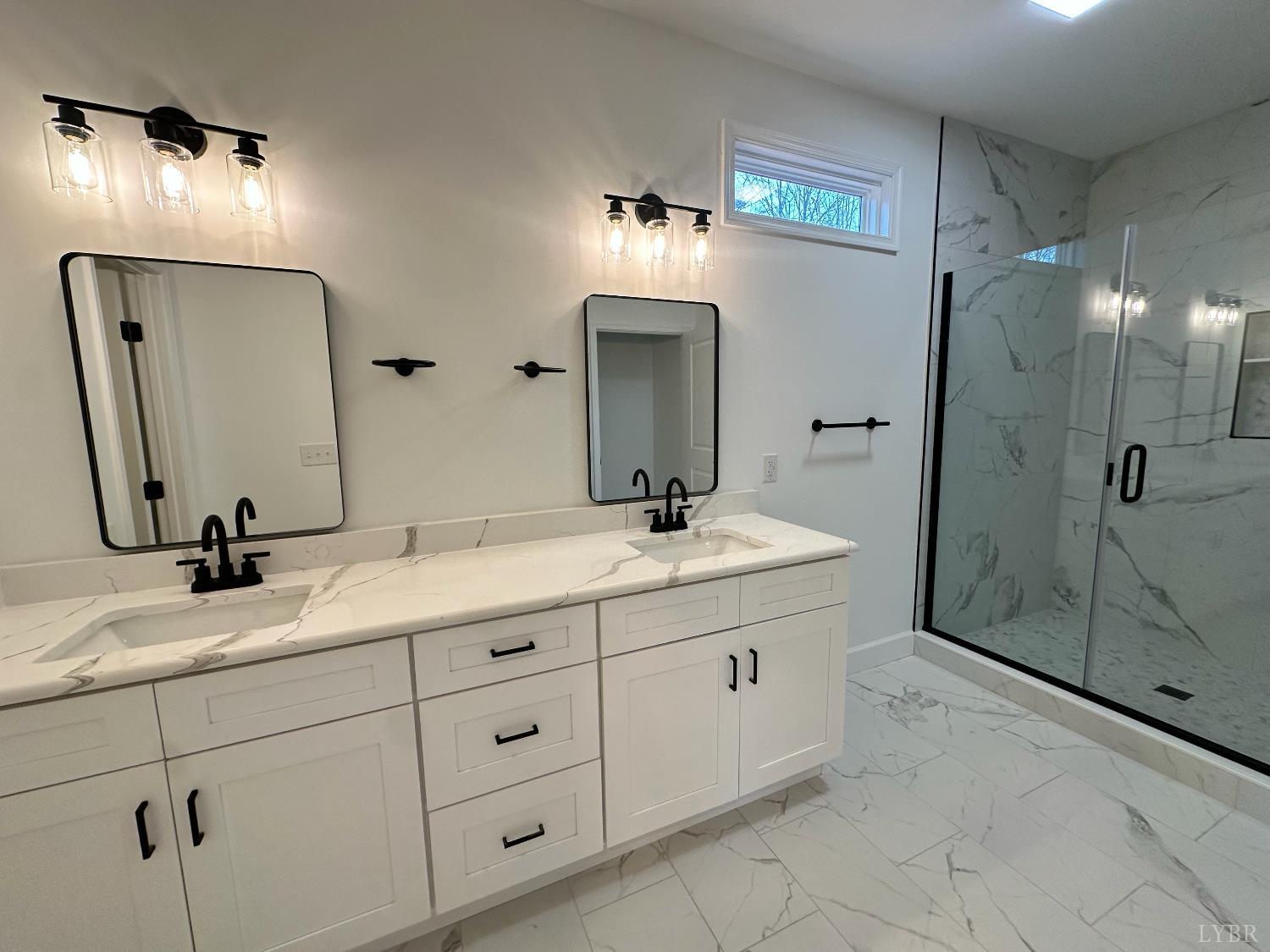 11314 Leesville Road Evington, VA 24550 - Photo 14 of 28 a bathroom with a double vanity sink and a mirror