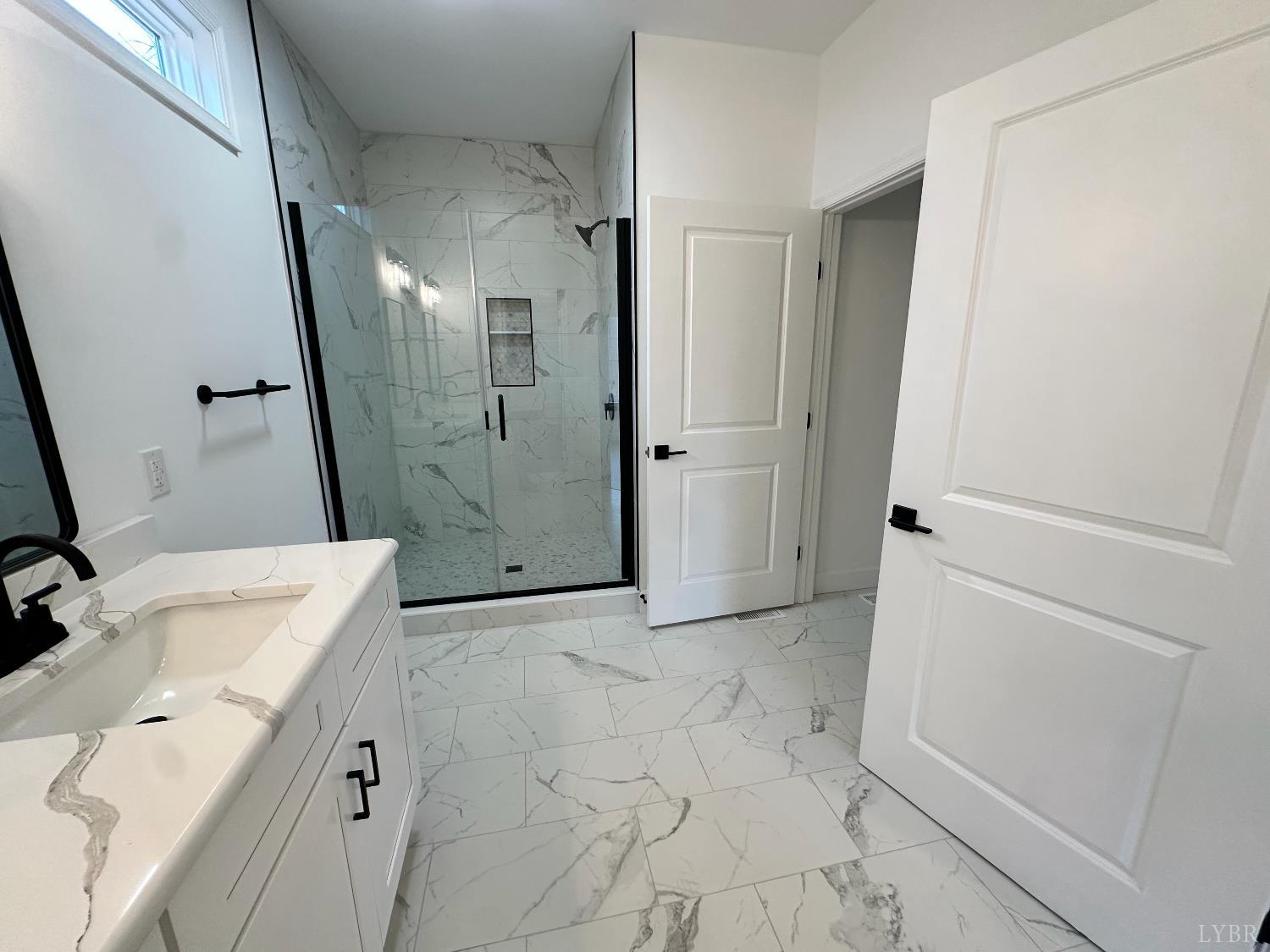 11314 Leesville Road Evington, VA 24550 - Photo 17 of 28 a bathroom with a sink vanity granite and shower